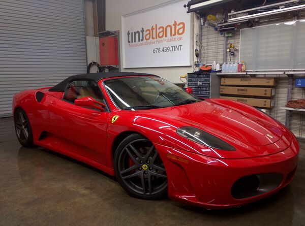 Red Ferrari F430 Spider convertible with premium window film at Tint Las Vegas shop