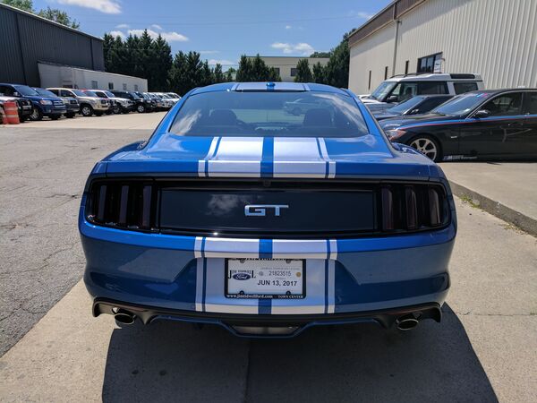 Blue Ford Mustang GT with racing stripes and tinted windows Las Vegas