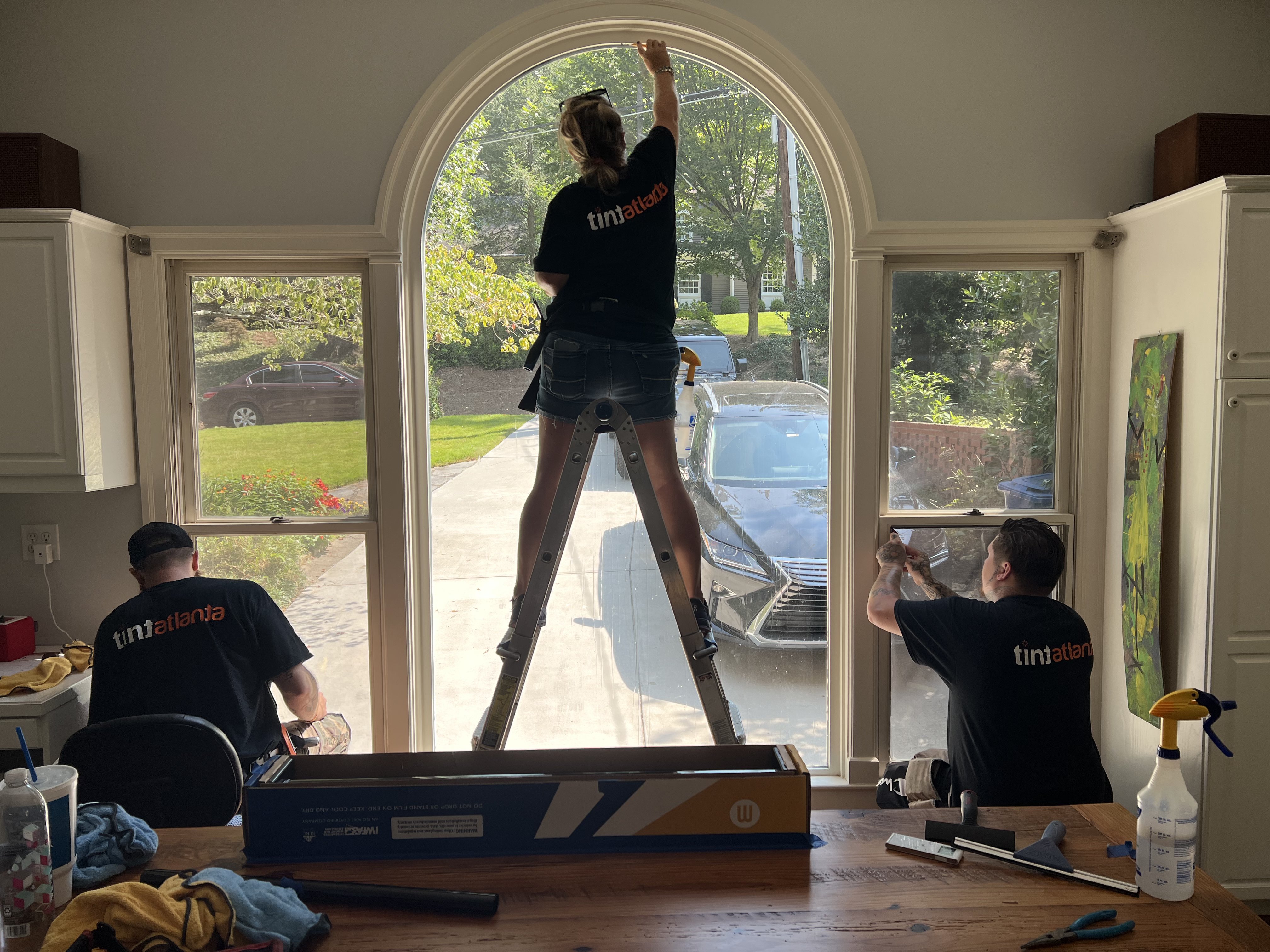 Tint Las Vegas team installing residential window film